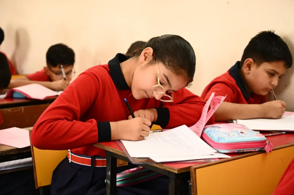 Class 10 student studying for board exams in a classroom