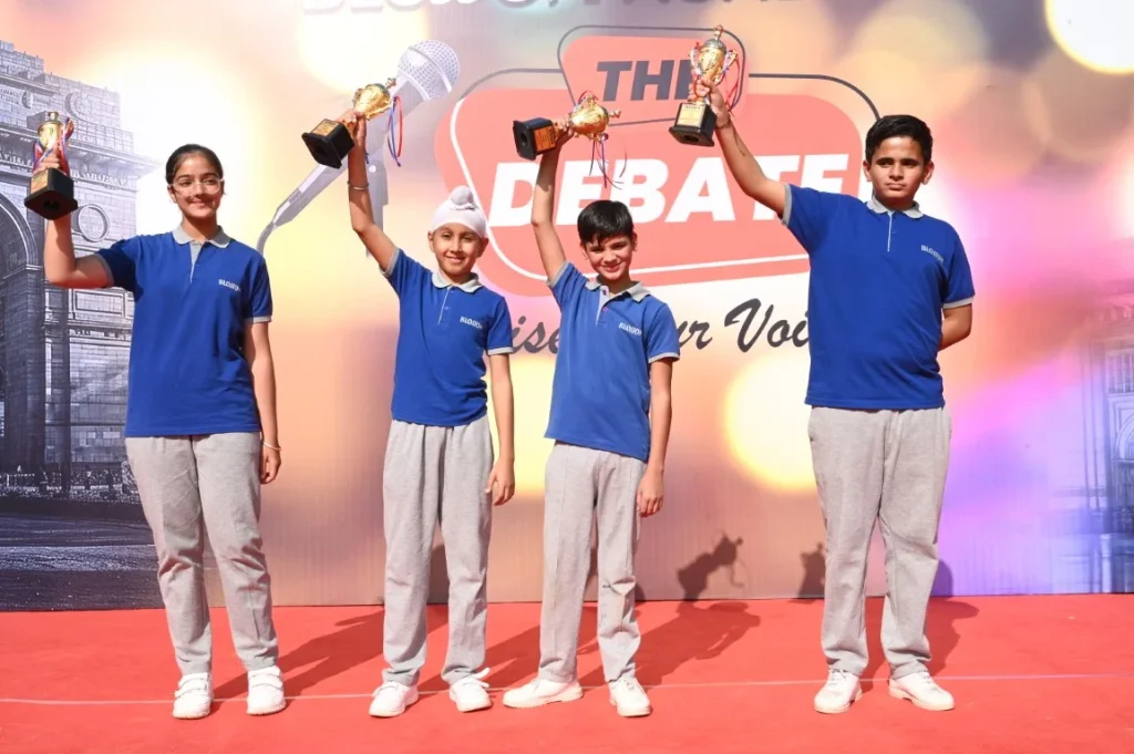 students holding trophies after school debate competition showcasing extracurricular activities at a CBSE school in Suratgarh