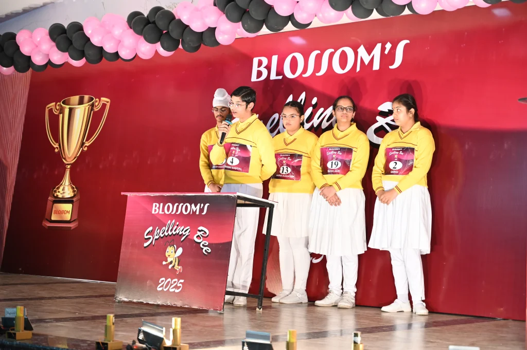 students participating in spelling bee competition on stage at CBSE school event in Suratgarh showcasing academic activities