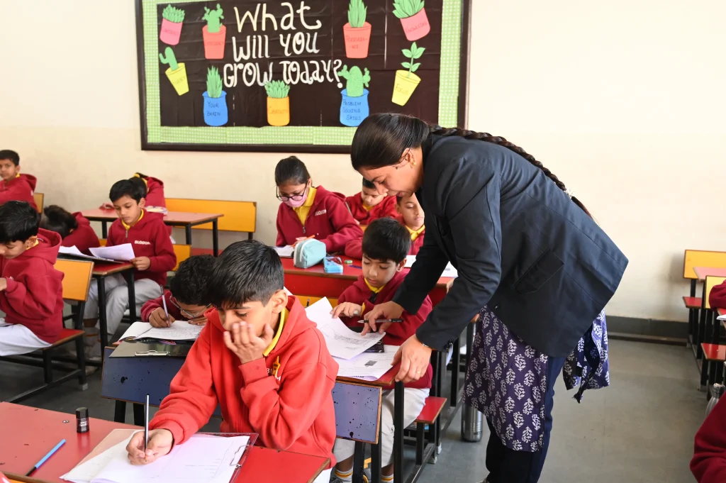 teacher guiding students during classroom learning session at CBSE school in Suratgarh showing academic support and interactive teaching